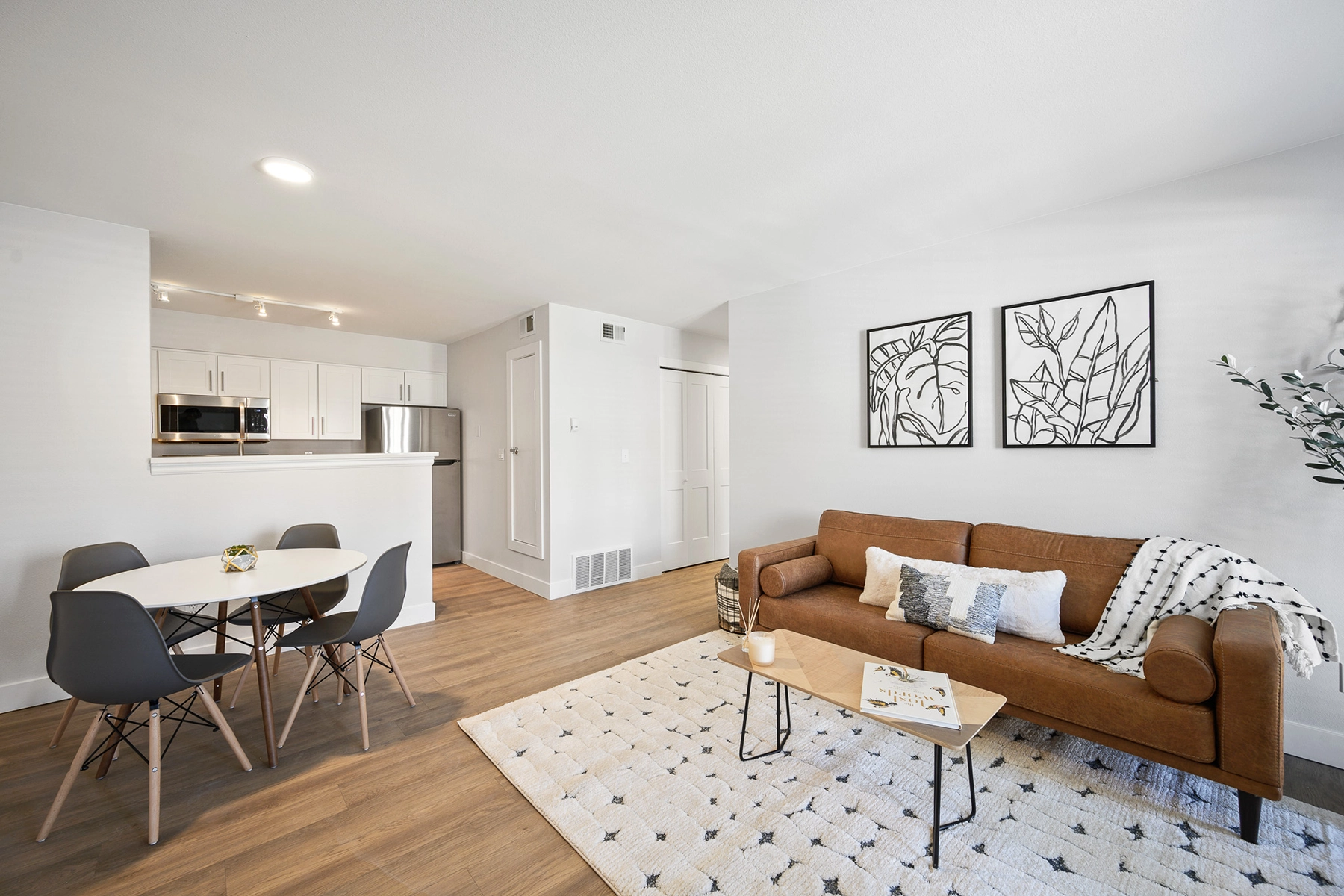 Model living room and dining area of student apartment at The Alpine