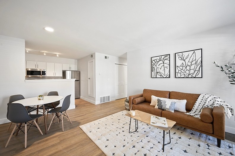 Open living room dining and kitchen in a model apartment at The Alpine