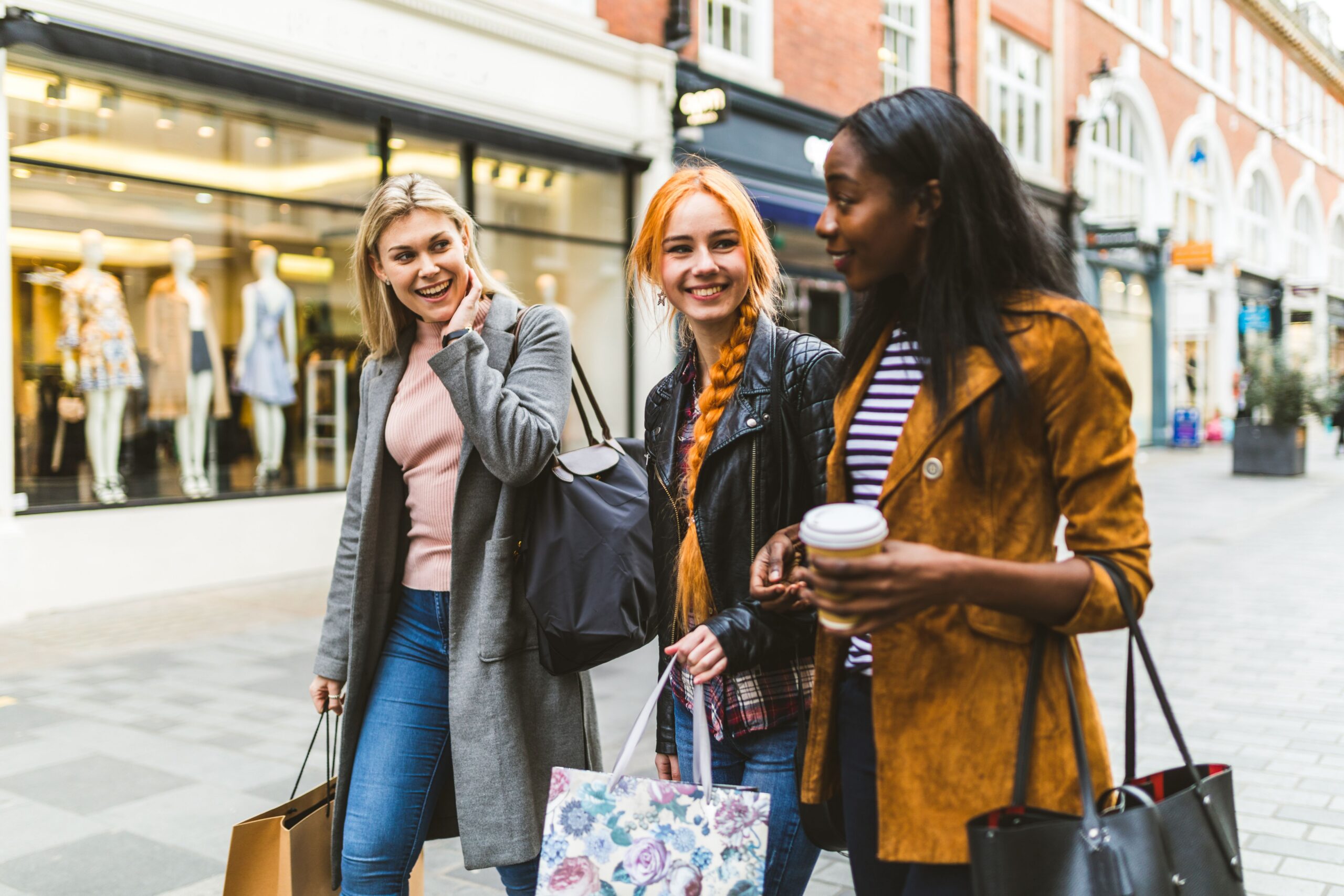 women shopping on city sidewalk scaled
